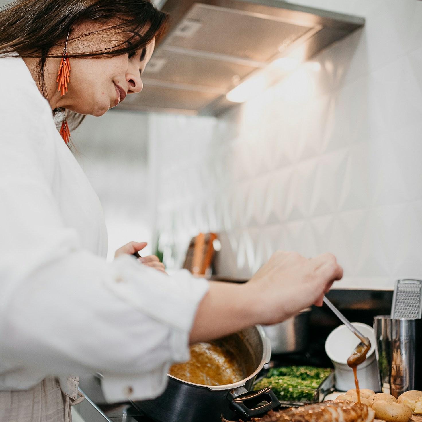 Community members working together in a modern kitchen, sharing recipes and cooking techniques