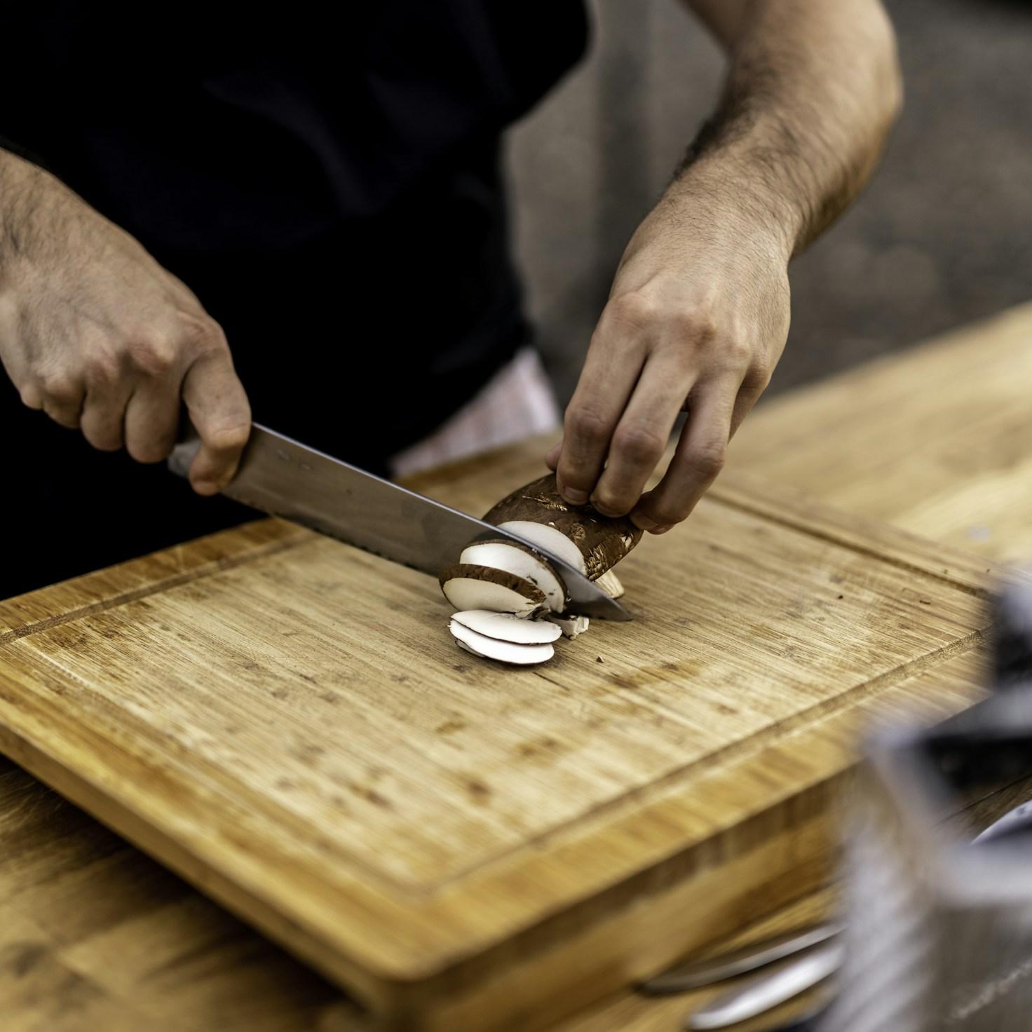 Diverse group of community members sharing a meal, illustrating the bonds formed through collaborative cooking